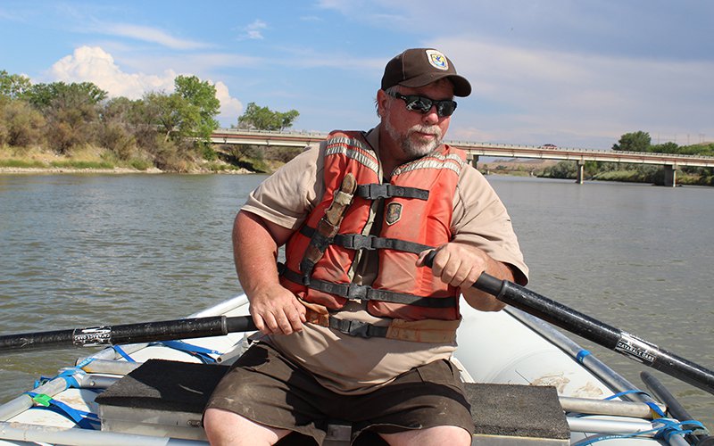 Biologist paddles down river