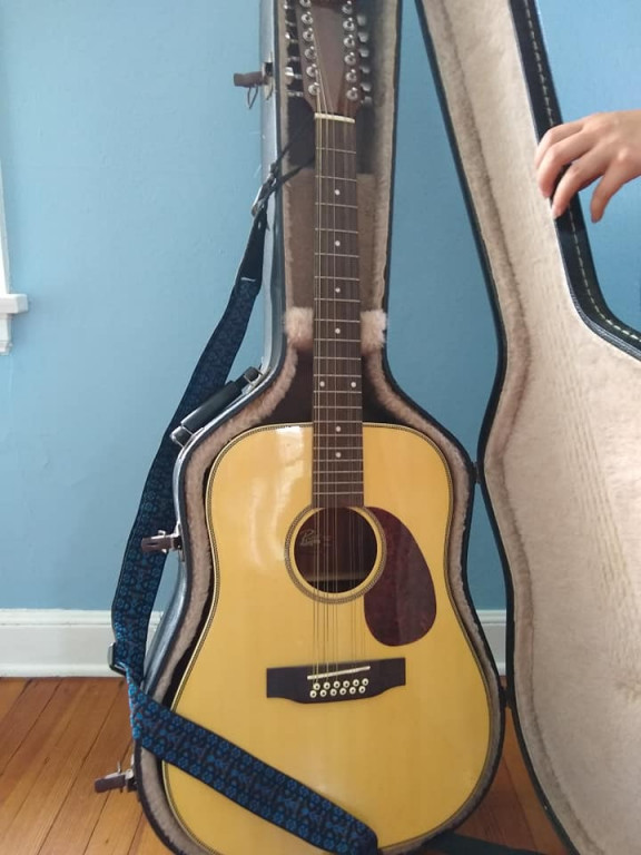 a formerly discarded 12-string guitar 
