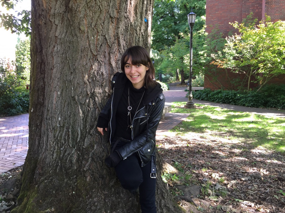 Student activist Giselle Herzfeld poses in front of a tree.
