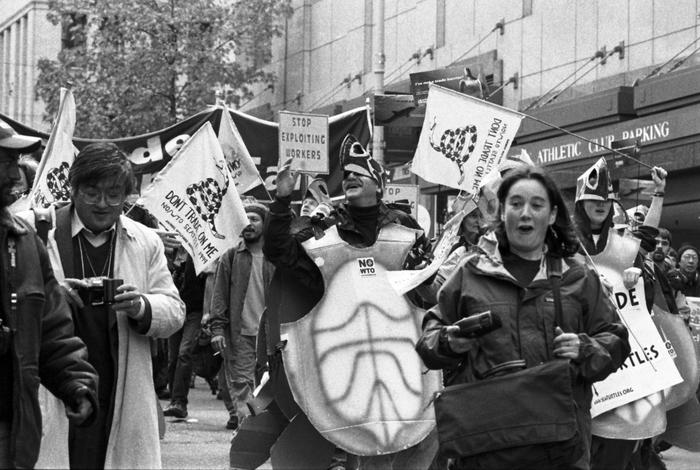 Labor activists join environmentalists wearing turtle costumes at the 1999 WTO protests in Seattle, Washington.