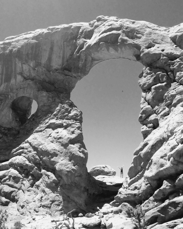 A black and white image of a rock arch at Arches National Park in Utah.