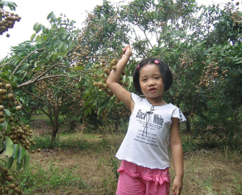 The author as a young girl, standing in an orchard at her grandparents' farm.