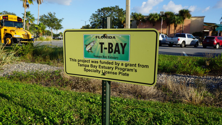 A sign with a picture of a "tarpon tag" license plate. The text underneath states, "This project was funded by a grant from Tampa Bay Estuary Program's Specialty License Plate"