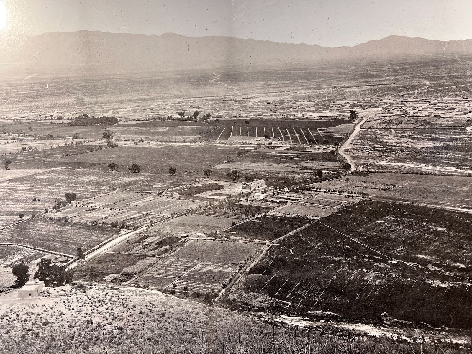 Black and white photo of a view from a mountain. The Santa Cruz runs in dozens of shallow canals below.