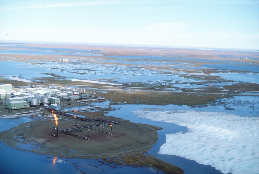 Aerial view of an oil field surrounded by ice sheets.