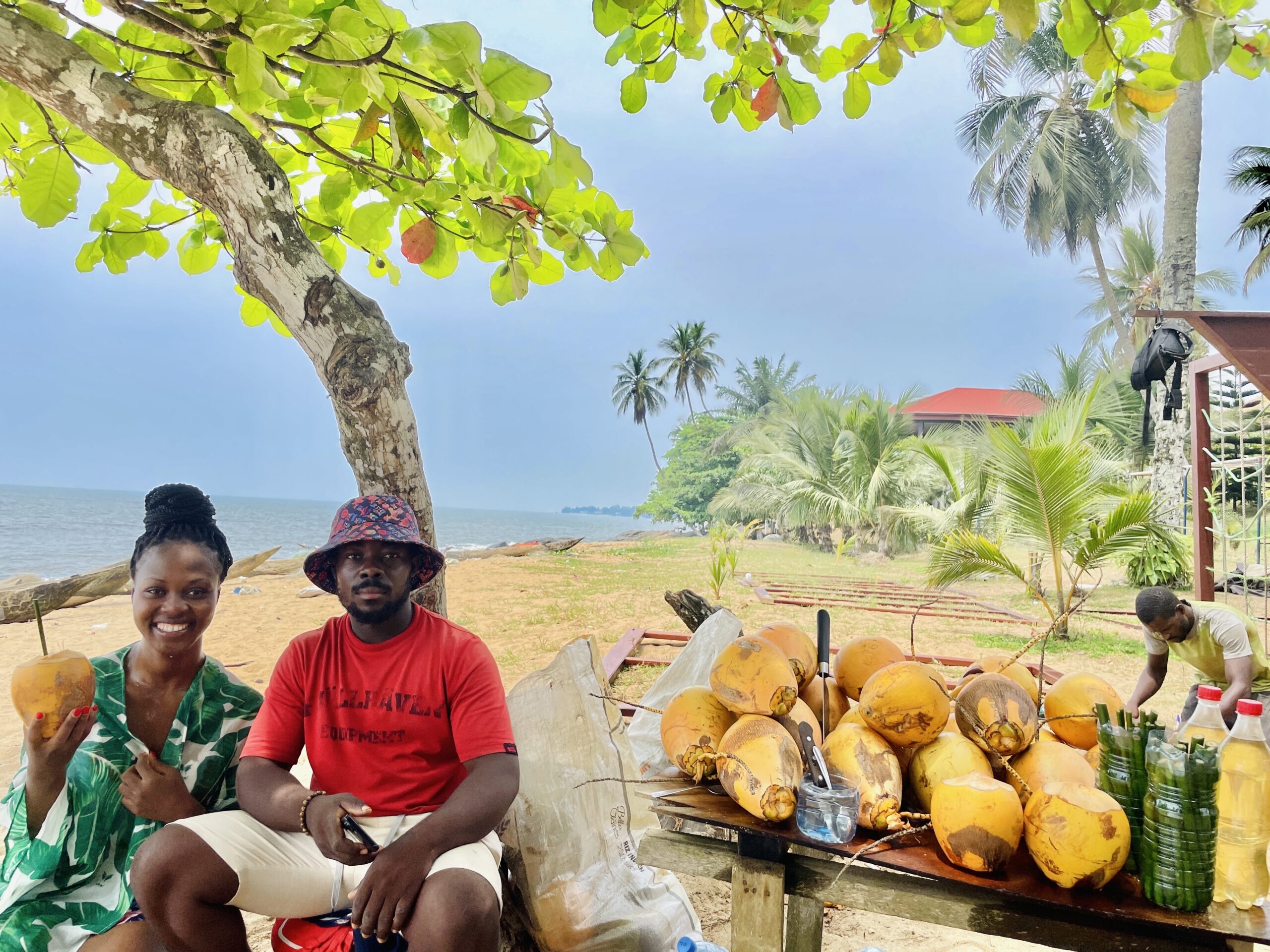 Moumboko Jacques Salvador and the author at Kribi beach in Cameroon where Salvador sells coconut water through bamboo straws.
