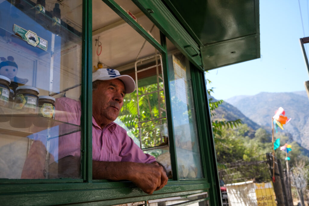Juan Muñoz sells Jesus Carrasco’s goat cheese and local honey on the side of the Camino Al Volcán, a highway that connects the Cajon del Maipo to Santiago city.
