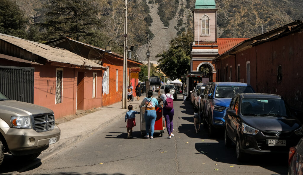 A group of women push a food cart through the streets of the San Jose del Maipo, a popular ecotourism destination and the largest township in the Cajon del Maipo valley.
