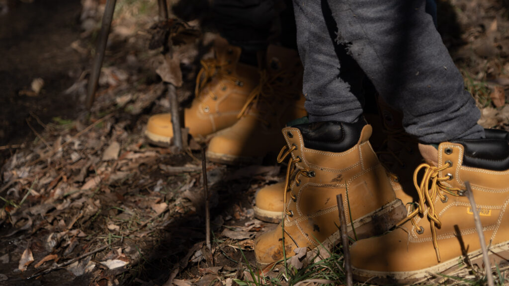 Tan work boots are worn by students outside. These are provided by the Organization, Wildland Restoration Volunteers in order to help hispanic students regain access to the outdoors.
