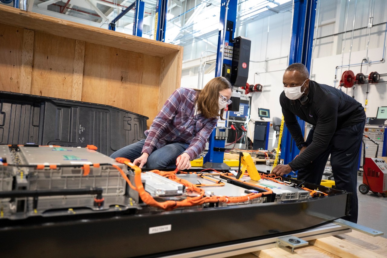 Dane Hardware, Ford Motor Co. design and release engineer, and Mary Fredrick, Ford Motor Co. battery validation engineer, examine internal components like cell arrays, wiring and contactor switches at Ford’s Battery Benchmarking and Test Laboratory in Allen Park, Michigan.