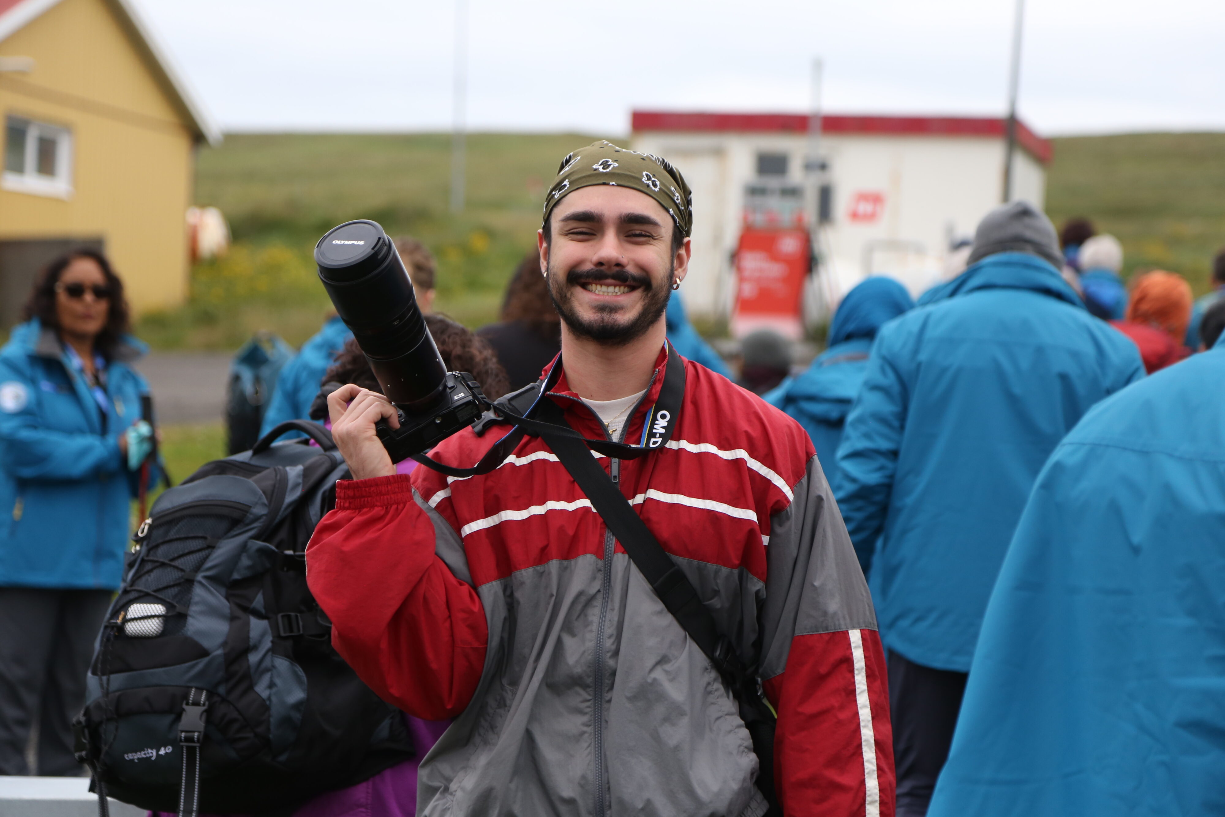 Portrait photo of Danny Stipanovich holding up a camera. 