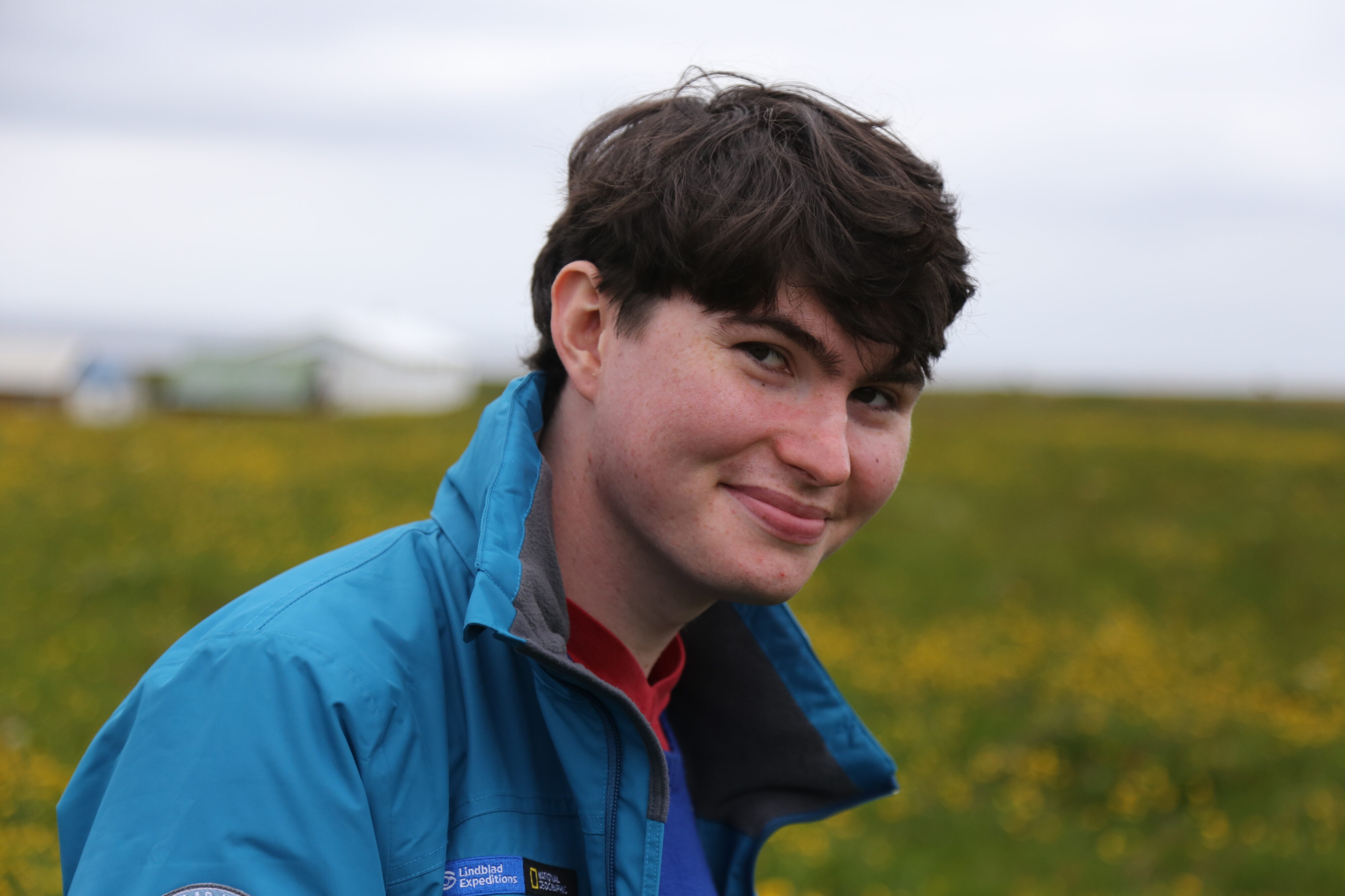 Portrait photo of Micah Seidel in a field in Iceland. 