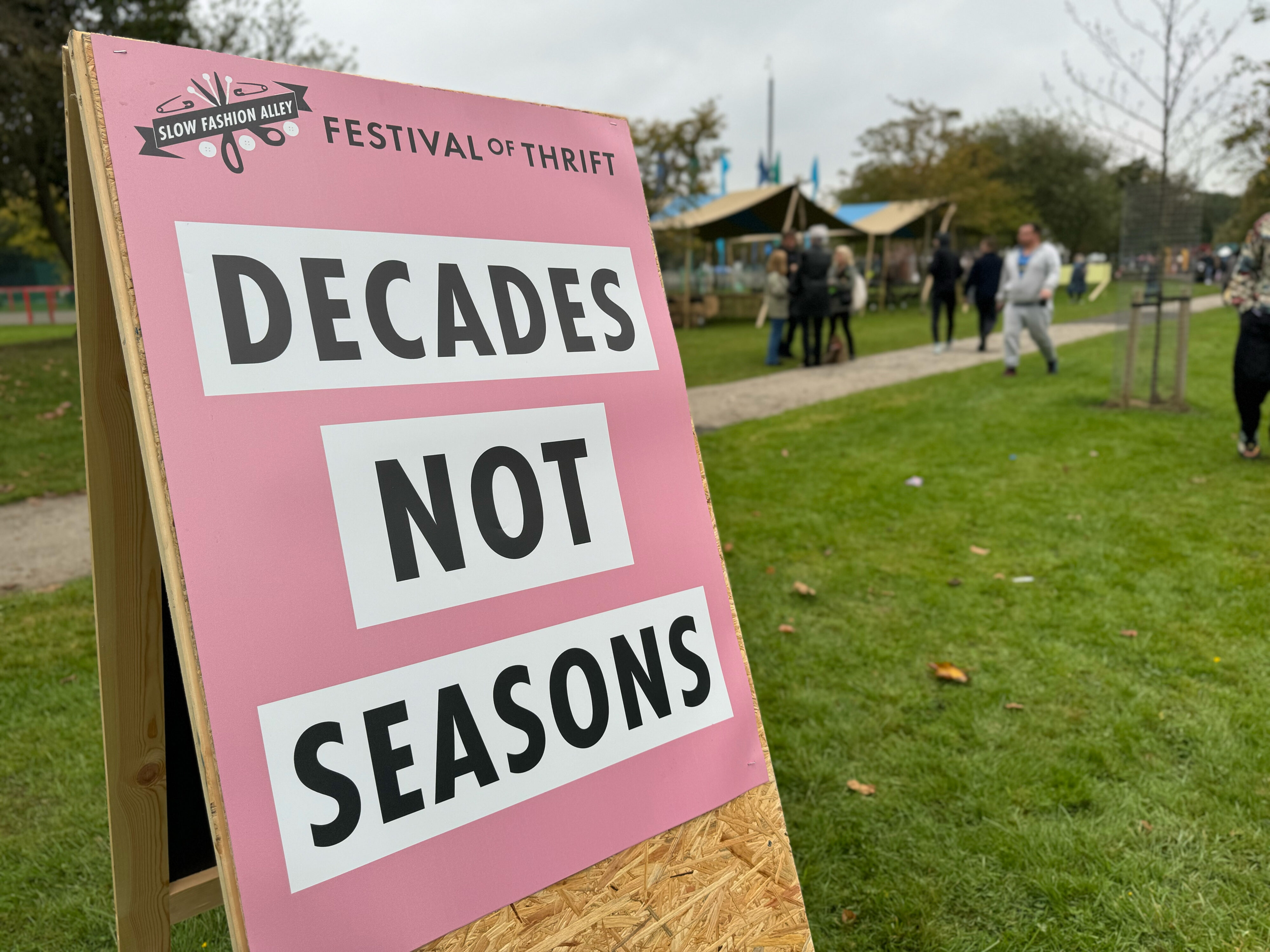 A sign at the festival reading, "Decades not Seasons."