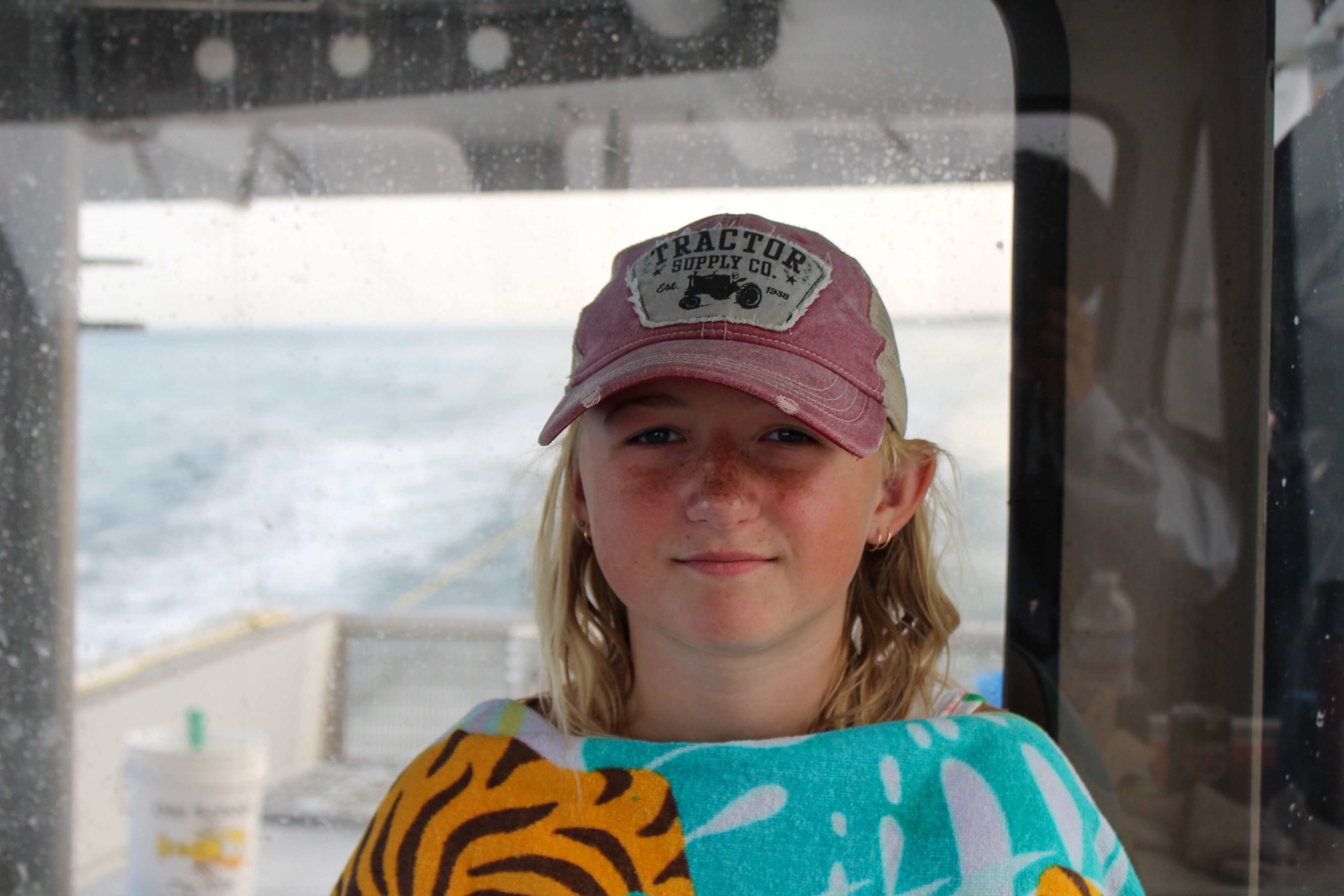 A 12 year old girl, Iris Bly, stares into the camera on her dad's boat. 