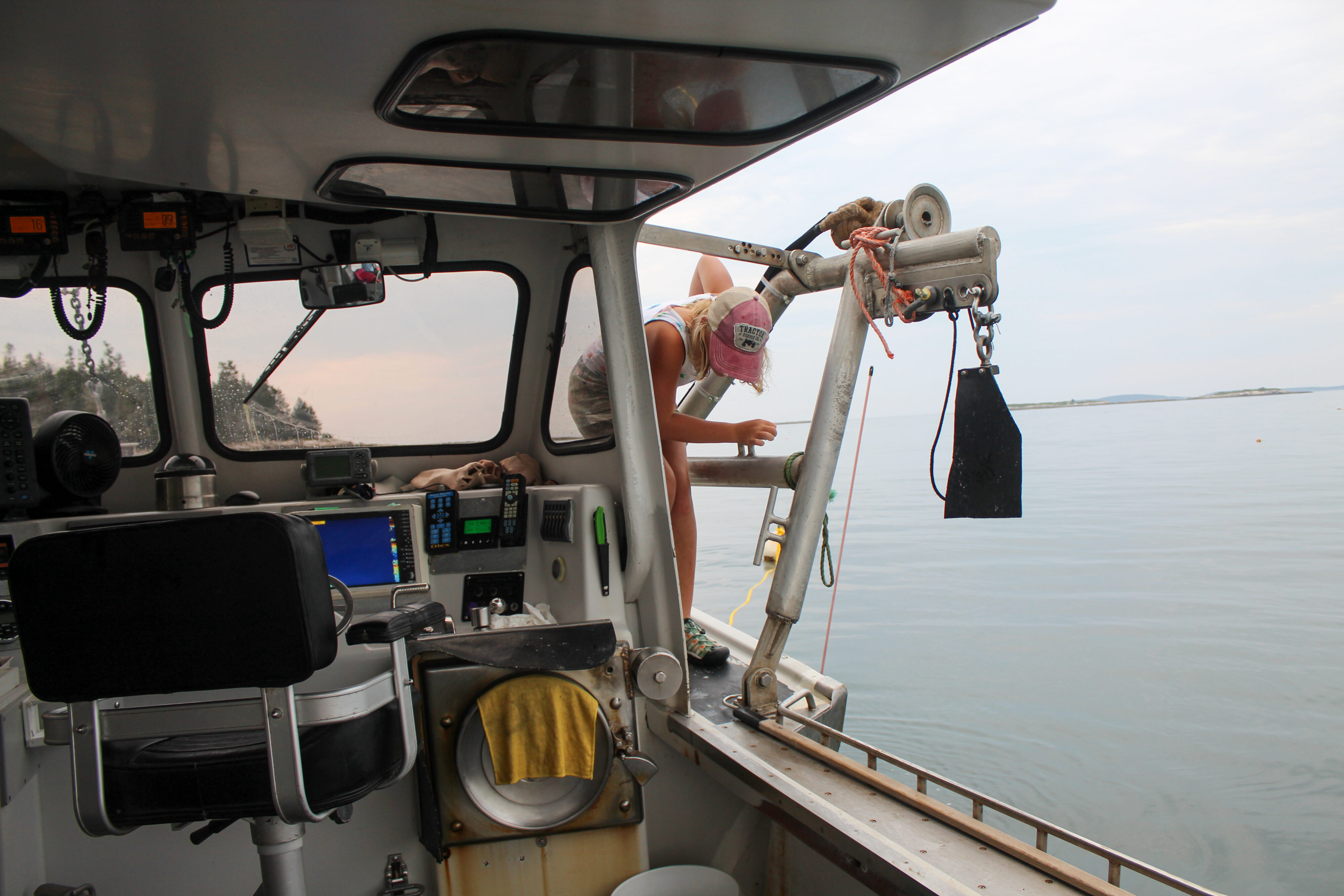 Iris navigate around the cockpit area of the boat. 