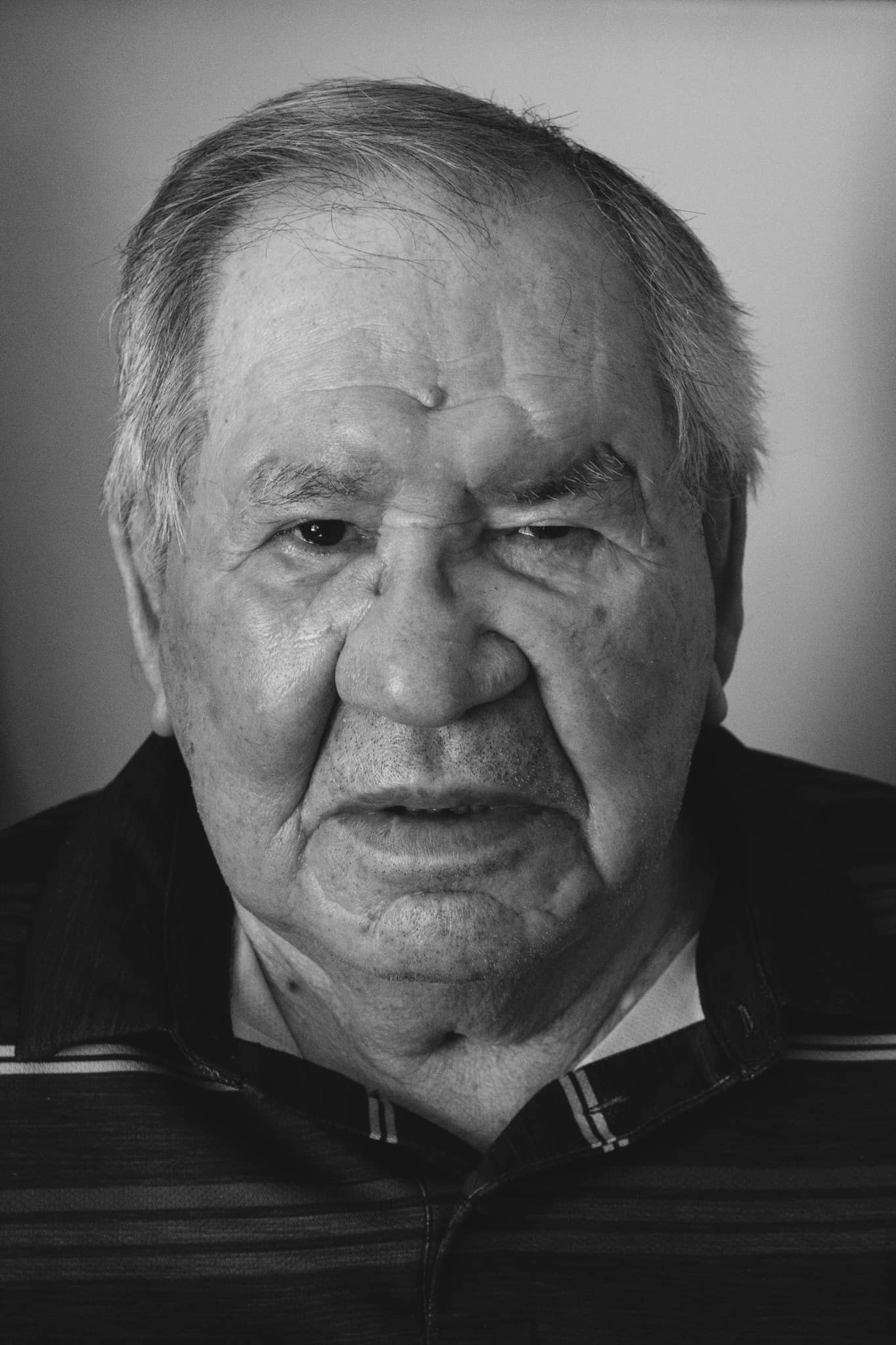 Indigenous Elder, Joe, is captured in a black-and-white portrait photograph.