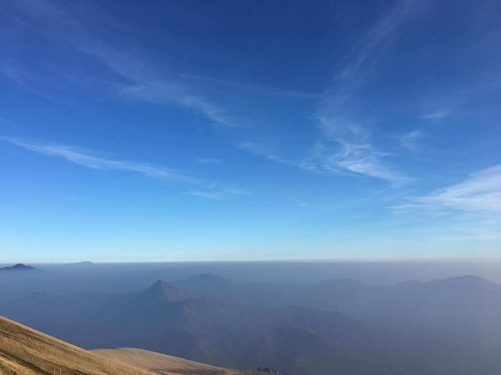 An image taken from a high mountain showing the Po Valley covered in. a dense haze.