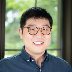 Headshot of a man in glasses.