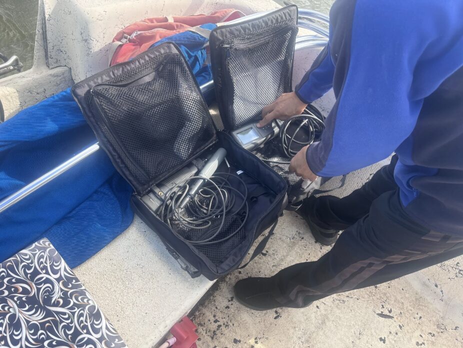 A person opens two cases of equipment.