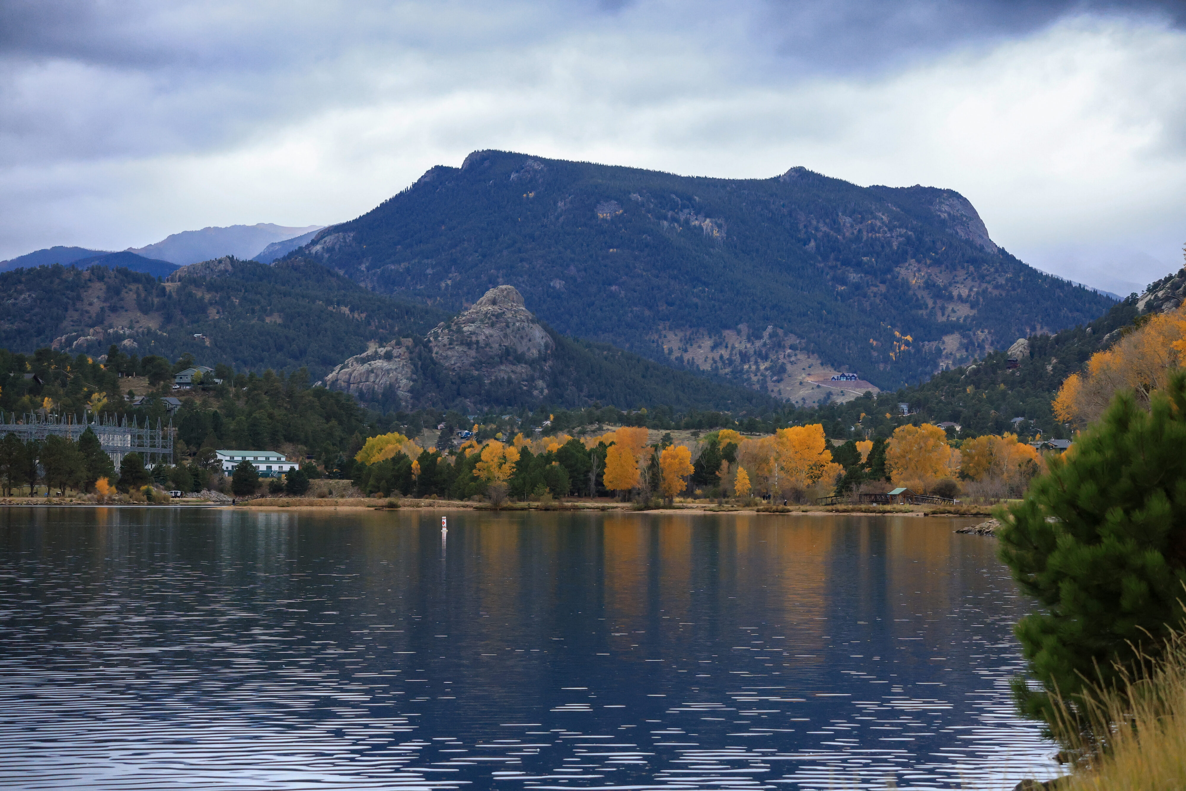 A lake in front of a mountain.