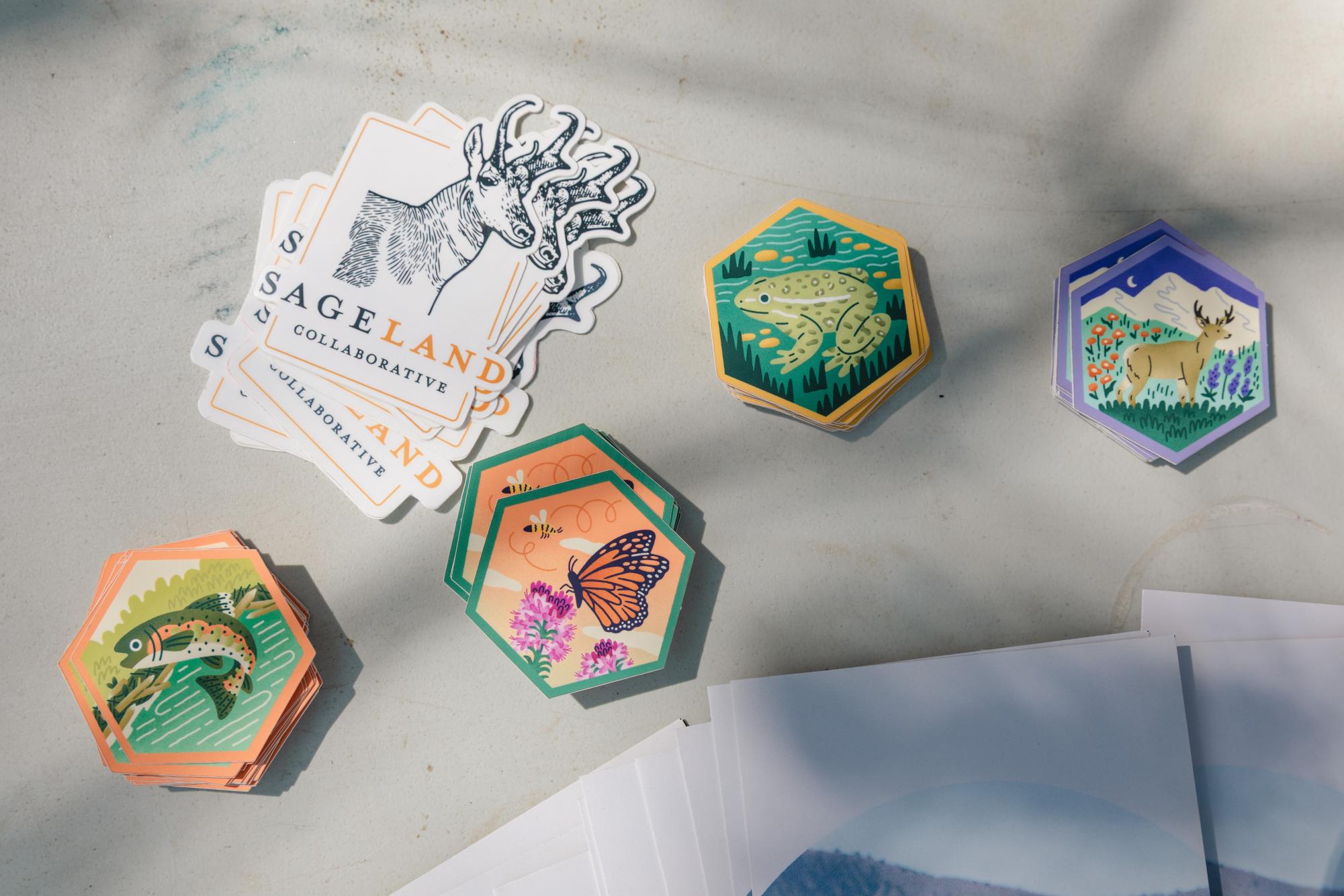 Piles of illustrated hexagonal stickers.