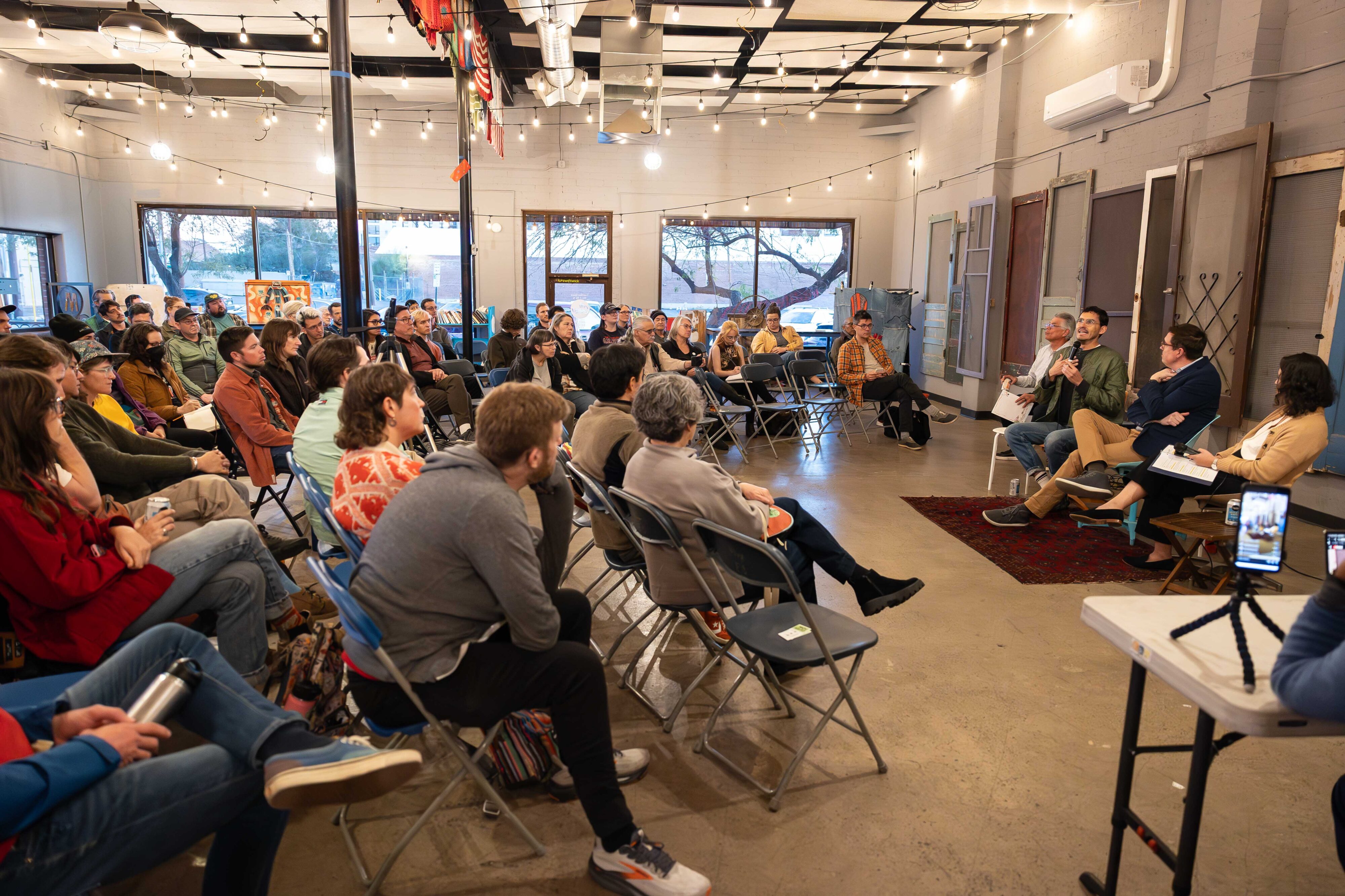 A crowd watching a panel.