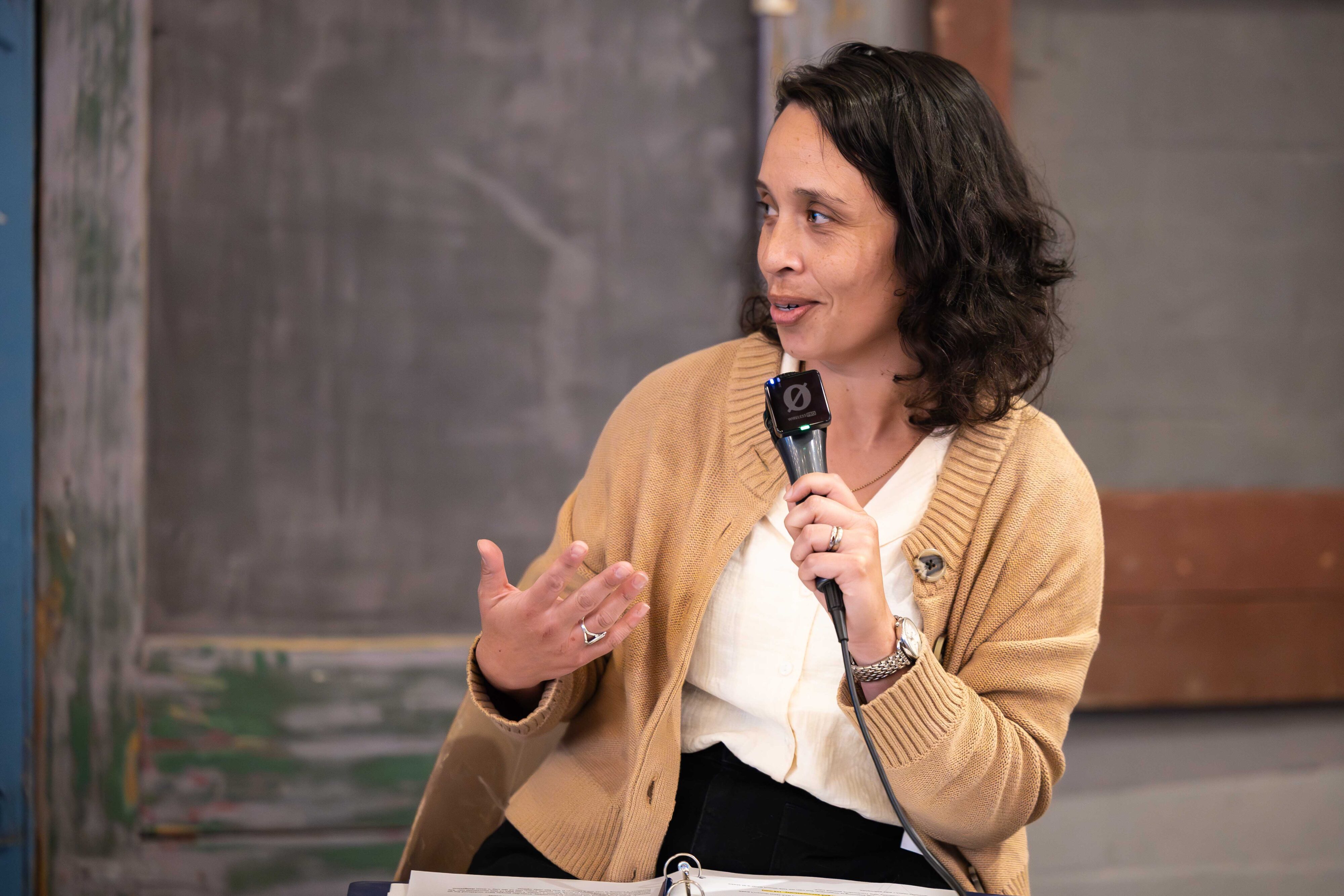 A woman speaking into a microphone.