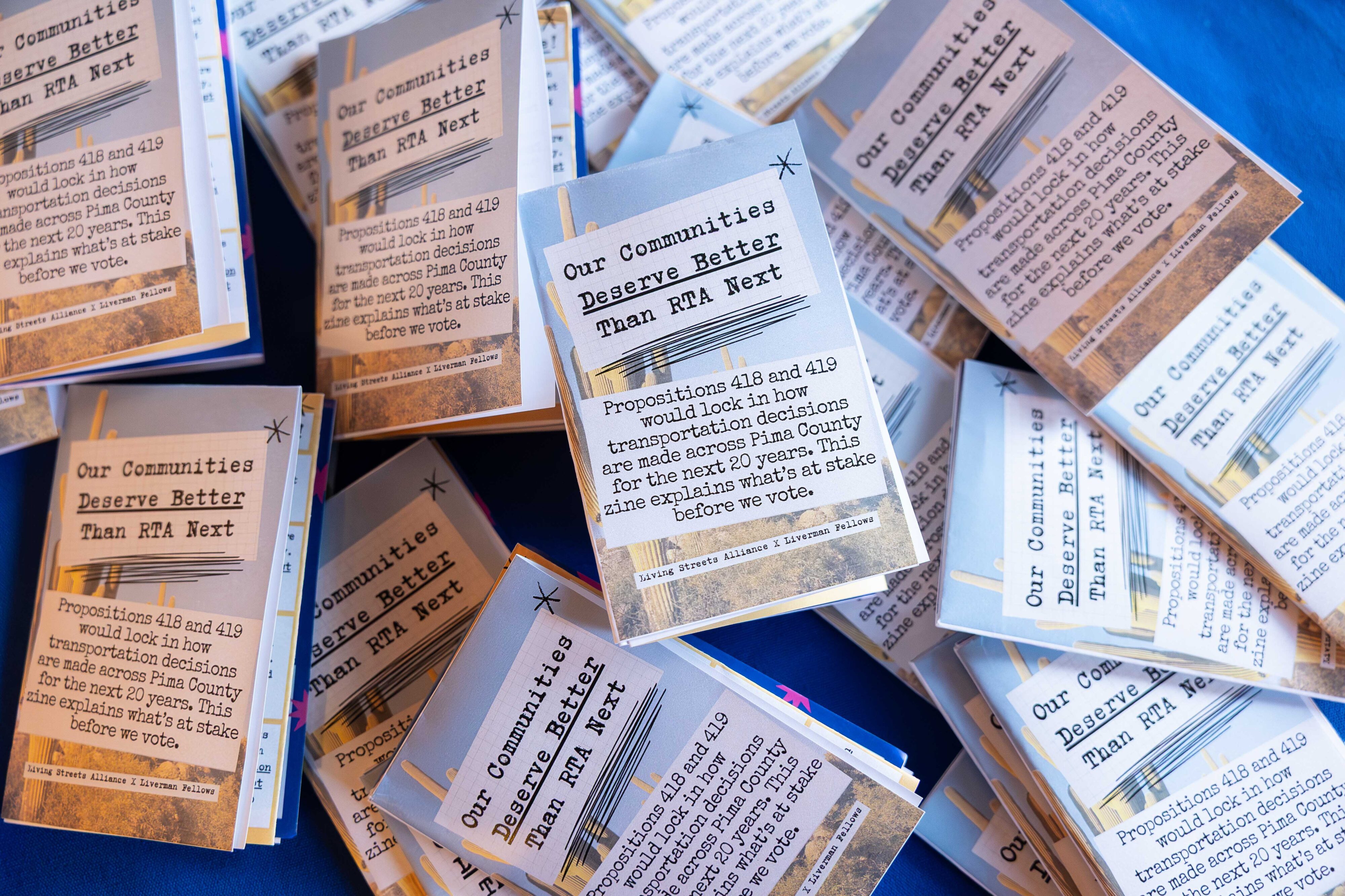 Stacks of small printed zines titled “Our Communities Deserve Better Than RTA Next."