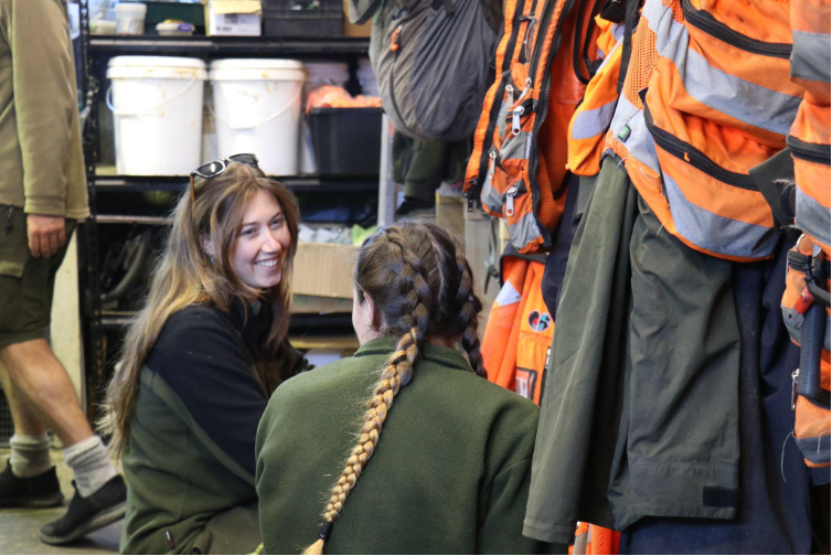 Two field operators gather equipment.